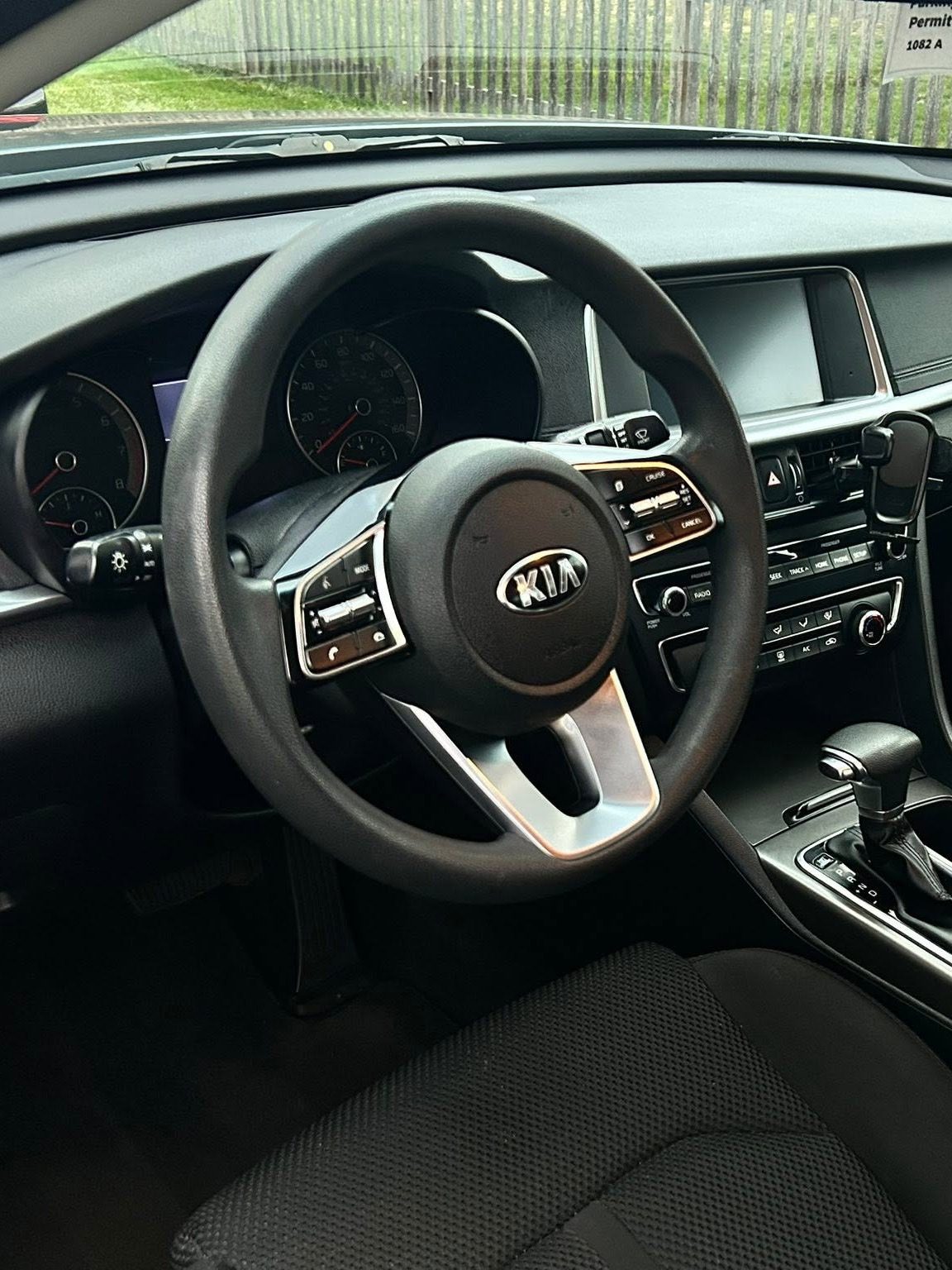 The same Kia Optima after an interior detail: clean carpet, dash, and seats